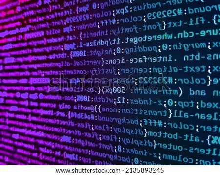 Computer code on laptop (web developing). Letters, chars, and digits. Screen of web developing code on dark background. Binary computer code background, abstract. Code on dark background