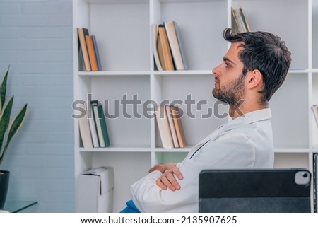 doctor in hospital relaxed at desk