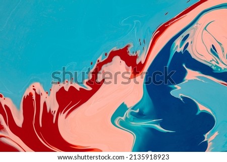 A mixture of dyes creates a fluid art texture. The abstract liquid background is composed of colored waves and swirling elements. The colors blend makes a creamy or wavy backdrop.