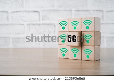 Global communication network concept, Wooden cubes with 5G and wifi icon on wooden desk, Worldwide business, high-speed mobile Internet, new generation networks. Mixed media.
