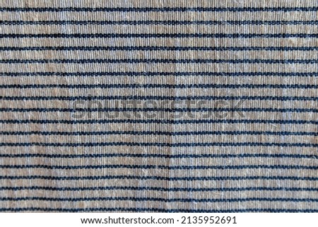 Picture of a horizontal alternating dark and white woven fabric texture. fabric material for furniture