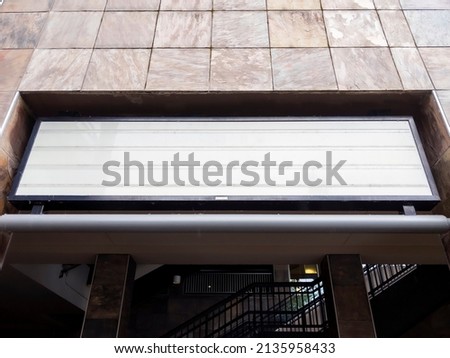 Low angle view of a blank, white letter board outside of a major outdoor shopping and business area in downtown Bellevue, WA