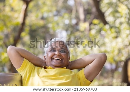 Happy senior man relaxing at park