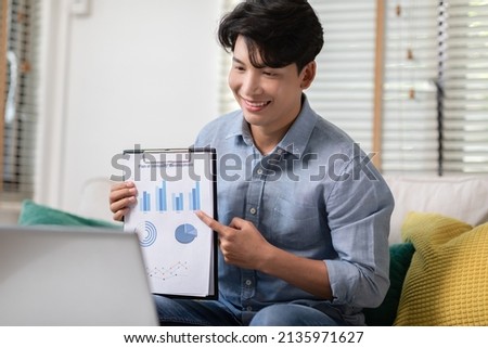 Asian business man is showing the data documents for the meeting conference groups. The paper containing company financial information and plan development for brainstorming with business partners. Royalty-Free Stock Photo #2135971627