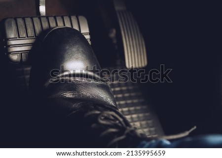 man stepping on car brake To slow down, stop the car both normal and abruptly, transfer the weight to press the front wheels to grip the road and turn more stable Royalty-Free Stock Photo #2135995659