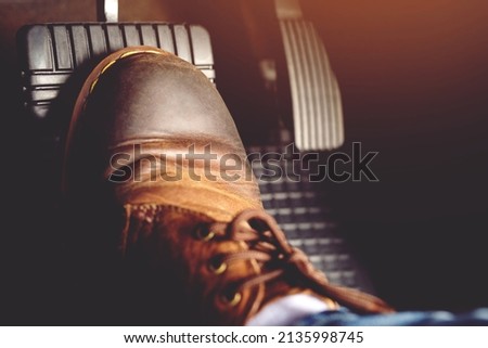 man stepping on car brake To slow down, stop the car both normal and abruptly, transfer the weight to press the front wheels to grip the road and turn more stable Royalty-Free Stock Photo #2135998745