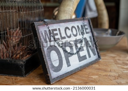 Welcome open sign at entry of local business