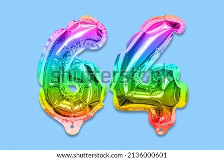 Rainbow foil balloon number, digit sixty four on a blue background. Birthday greeting card with inscription 64. Top view. Numerical digit. Celebration event, template.