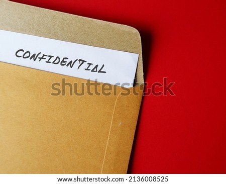 Office envelope with document typed CONFIDENTIAL, concept of data or information intended to be kept secret, secret or private, business or military top secret document Royalty-Free Stock Photo #2136008525