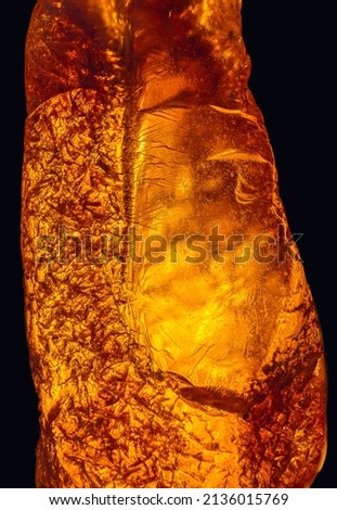 Natural amber texture. Multicolored background for advertising and banners. Vintage fossilized resin as a background. Red amber amber background. Close-up amber Royalty-Free Stock Photo #2136015769