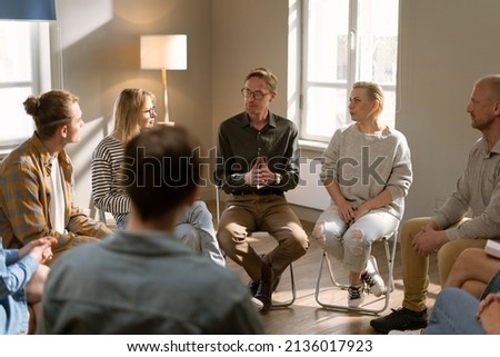 Diverse group of people sat in circle for a Therapy recovery meeting Royalty-Free Stock Photo #2136017923