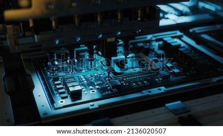 Automatic Pick and Place machine quickly installs Components on Circuit Board. Electronics and Circuit board Manufacturing. Dark Environment Royalty-Free Stock Photo #2136020507