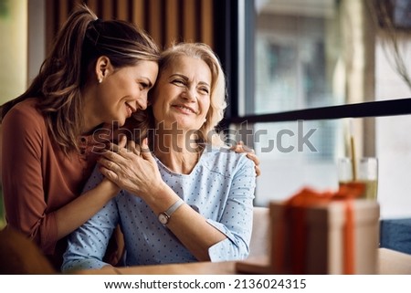 Happy senior woman enjoying in daughter's affection on Mother's day. Royalty-Free Stock Photo #2136024315