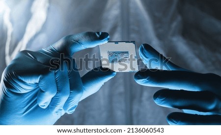 Setting operating modes electronic controllers on a Microchip Engineer hold it for testing microelectronics at a Ultra Modern Electronic Manufacturing Factory Royalty-Free Stock Photo #2136060543