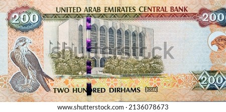Large fragment of reverse side of 200 AED two hundred Dirhams banknote of United Arab Emirates that features the imagery of the Central Bank of the UAE and a falcon image, Emirates money banknote Royalty-Free Stock Photo #2136078673
