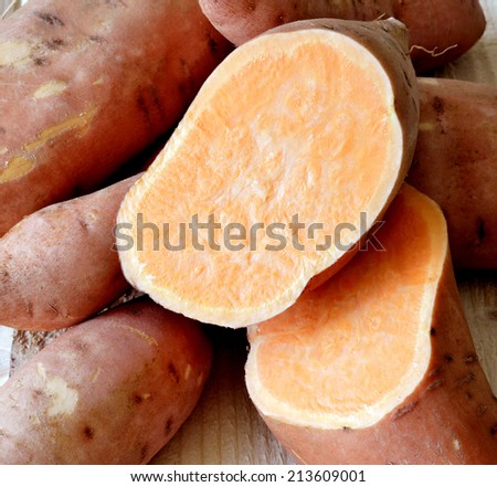 Sweet potatoes ripe juicy beautiful on a wooden table.