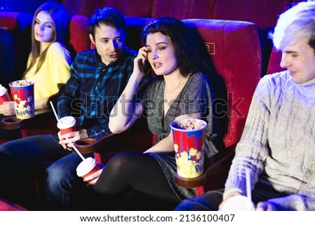 Annoying woman on the phone during movie at the cinema