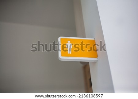 Male toilet sign on the white wall