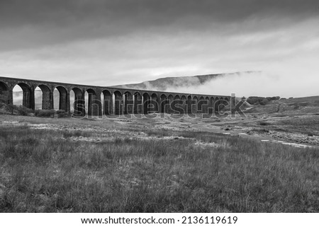 The Ribblehead Viaduct spanning into the distant fog.  Yorkshire Dales. Royalty-Free Stock Photo #2136119619