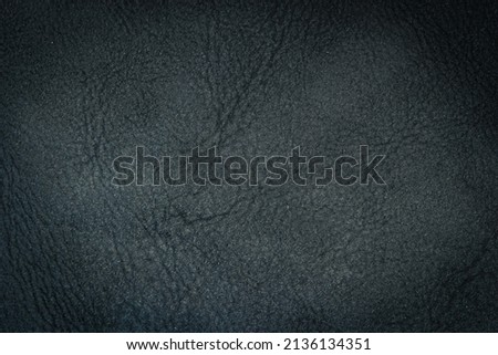Closeup detail of dark leather texture background.