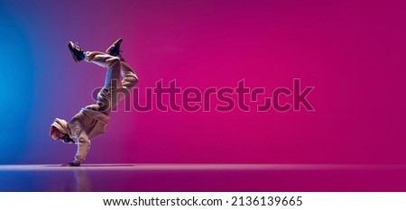 Flyer with young flexible sportive man dancing breakdance in white outfit on gradient pink blue background. Concept of action, art, beauty, sport, youth. Dancer shows breakdance figures Royalty-Free Stock Photo #2136139665