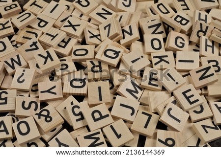 pile of wooden tiles with latin alphabet letters and characters