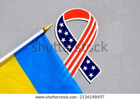 Flag of Ukraine and flag of the USA on grey background,cooperation sign , America stands with Ukraine photo