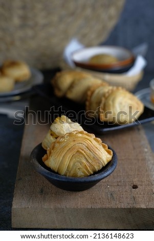 Deep fried curry puff or karipap served for appetizer snack. Selective focus