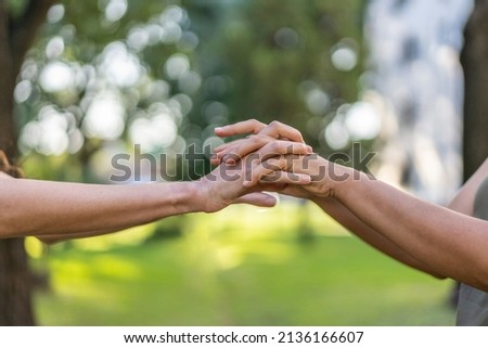 Holding hands close up of a women couple