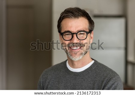 Senior Man Smiling At The Camera. In the kitchen. With glasses Royalty-Free Stock Photo #2136172313