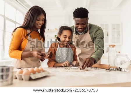 Happy Black Family Making Cookies Using Baking Forms Having Fun And Cooking Together Standing In Modern Kitchen At Home On Weekend. Pastry Recipes, Food And Nutrition Concept