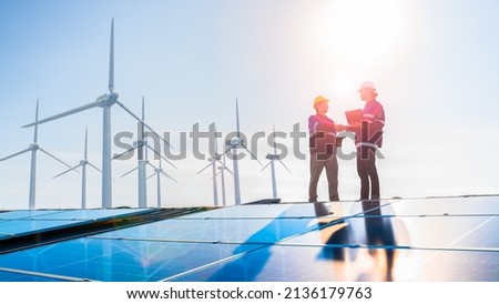 solar cell plant and wind generators in urban area connected to smart grid.Energy supply,wind turbine,eolic turbine,distribution of energy,Powerplant,energy transmission,high voltage supply concept. Royalty-Free Stock Photo #2136179763