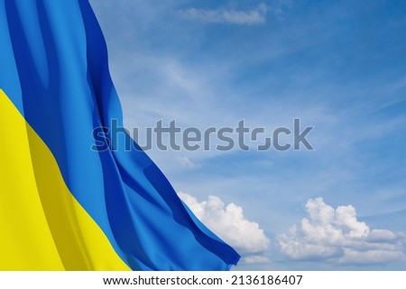 Ukraine flag on the blue sky with place for text. Close up waving flag of Ukraine. Flag symbols of Ukraine.