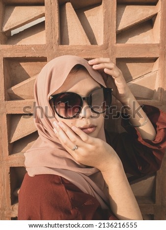 beautiful asian woman portrait pose wearing hijab and sunglasses