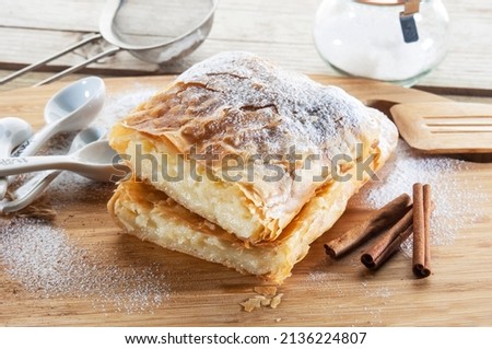 A typical Greek pie(bougatsa),its called Thessaloniki pie as well.
It is handmade phyllo stuffed with sweet semolina cream and a powdered sugar and cinnamon topping
