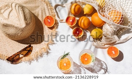 Summer fashion flat lay banner on white background. Holiday party, vacation, travel, tropical concept. Straw hat, sunglasses, refreshing drinks and citrus fruits. Palm shadow and sunlight. Top view Royalty-Free Stock Photo #2136228919