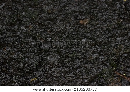 Dark nature abstract background of black highway surface texture.