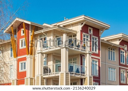 Brand new apartment building on sunny day in BC, Canada. Canadian modern residential architecture. Nobody, street photo,