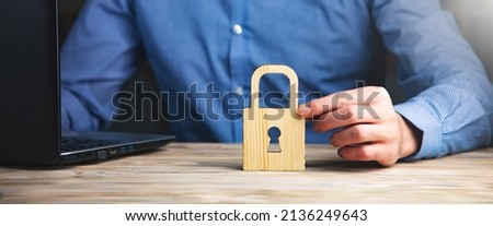wooden lock with man working on computer 