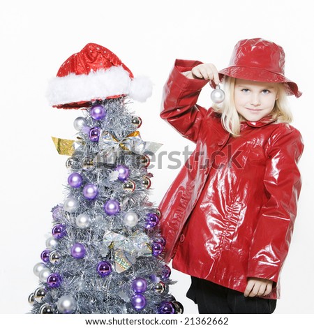 indoors picture of a little girl preparing christmas tree on isolated white background