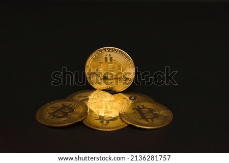 Bitcoin BTC crypto currency gold coins on black background, new virtual money concept. Mining or blockchain technology