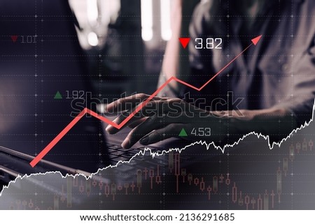 Economy graph: rising arrow on digital screen for woman with laptop. Inflation and stagnation, Abstract graphic symbolizing the economy of country. Royalty-Free Stock Photo #2136291685