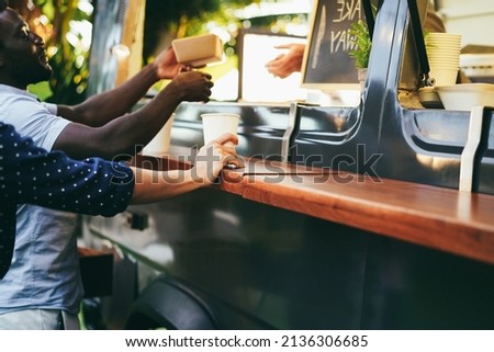 Multiracial people ordering food at counter in food truck outdoor - Focus on woman hand holding coffee Royalty-Free Stock Photo #2136306685