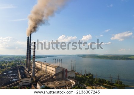 Aerial view of coal power plant high pipes with black smokestack polluting atmosphere. Electricity production with fossil fuel concept. Royalty-Free Stock Photo #2136307245