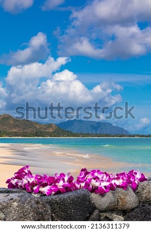 Fresh Lei Flowers Necklace on the beach, Oahu Hawaiian Island Tropical Vacation Background. Hawaii Luau Icon Travel Concept. Selective focus.