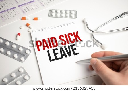 Pills, covid test and a medical phonendoscope with the inscription paid sick leave on a blue background. FMLA Family Medical Leave Act Royalty-Free Stock Photo #2136329413