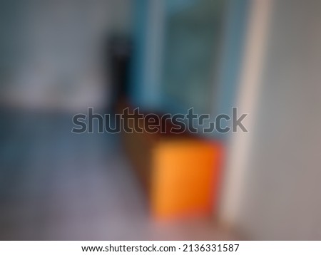 Defocused abstract background of a long brown wooden table in a classroom