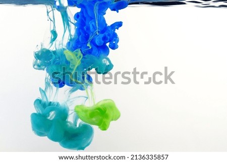 photo of paint falling into the water