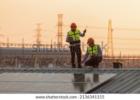 Solar cells have been maintained and maintenance by a team of engineers.  two engineers checking solar cells on power plant background.  Royalty-Free Stock Photo #2136341155