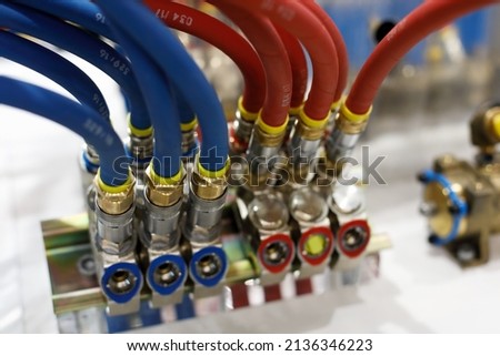 Reinforced rubber air hoses with pneumatic fittings. Selective focus. Royalty-Free Stock Photo #2136346223